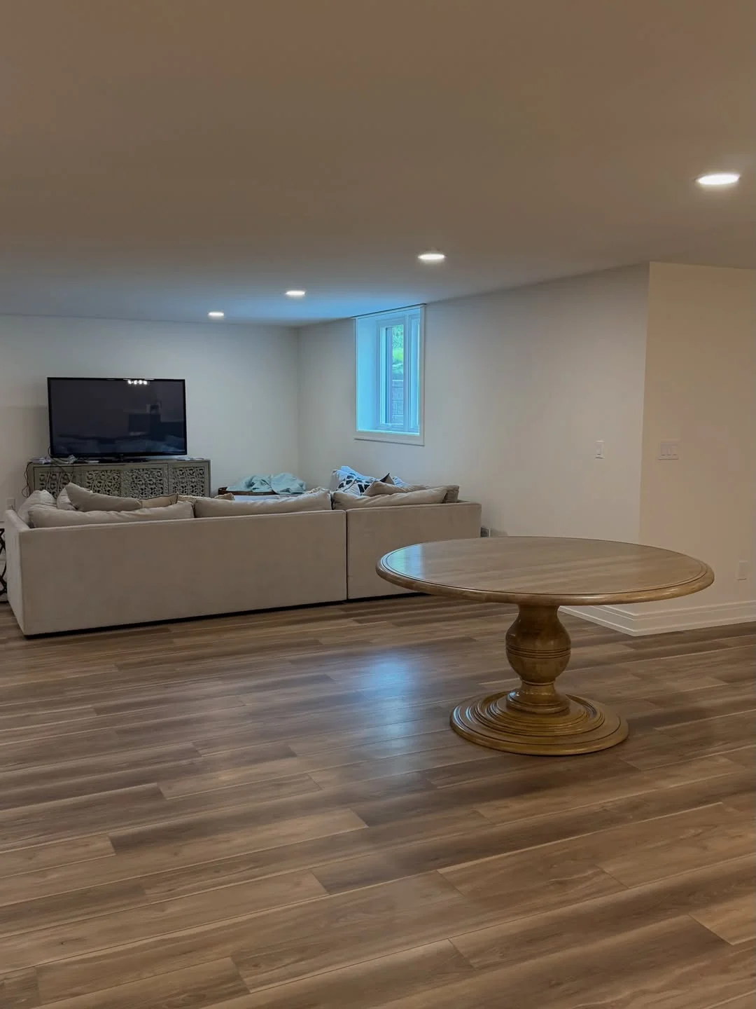 Finished basement with hardwood flooring, recessed lighting, drywall, and living room setup